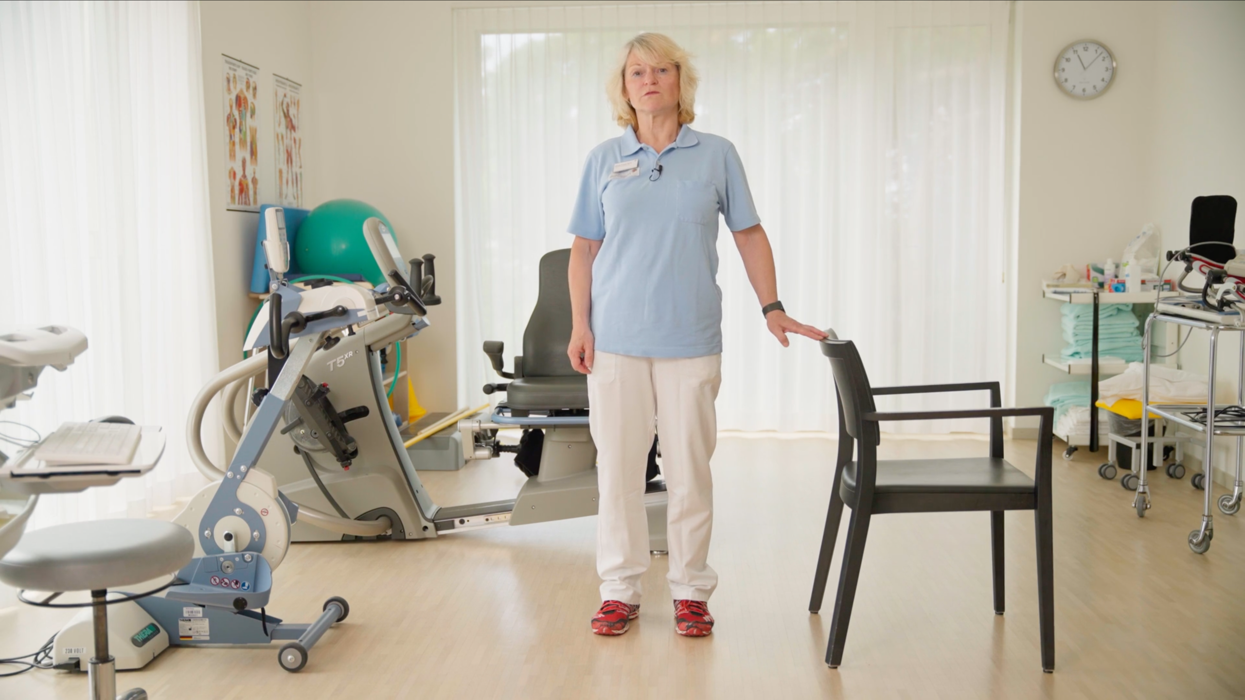 Physiotherapeutin zeigt Gleichgewichtsübung